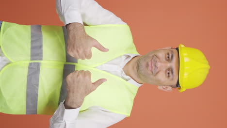 Vertical-video-of-The-engineer-wearing-a-hard-hat-and-smiling.